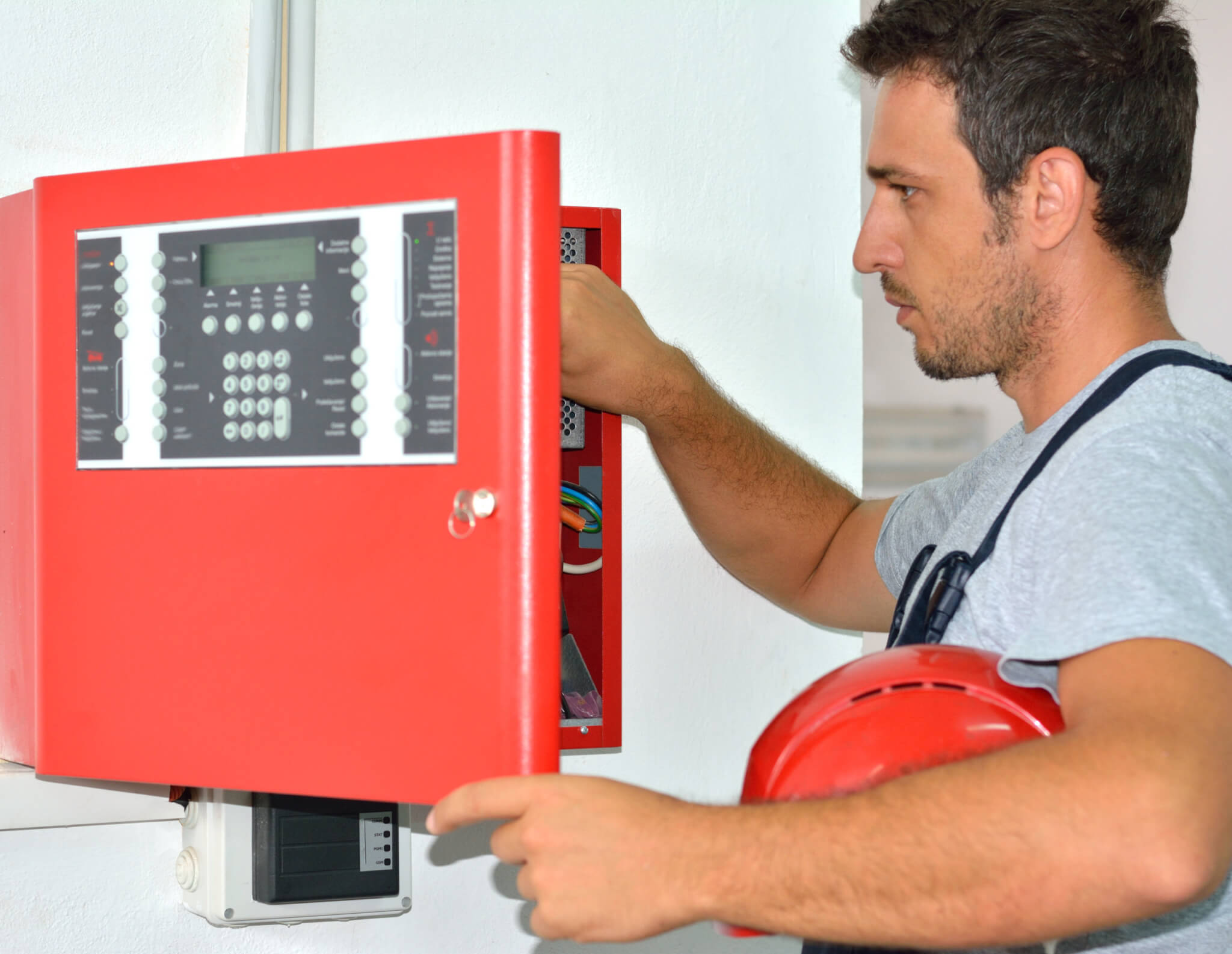 Manual worker working on electrical equipment.